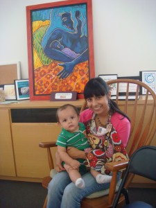 A mother and baby with Kathy's painting "Blue mother" in background